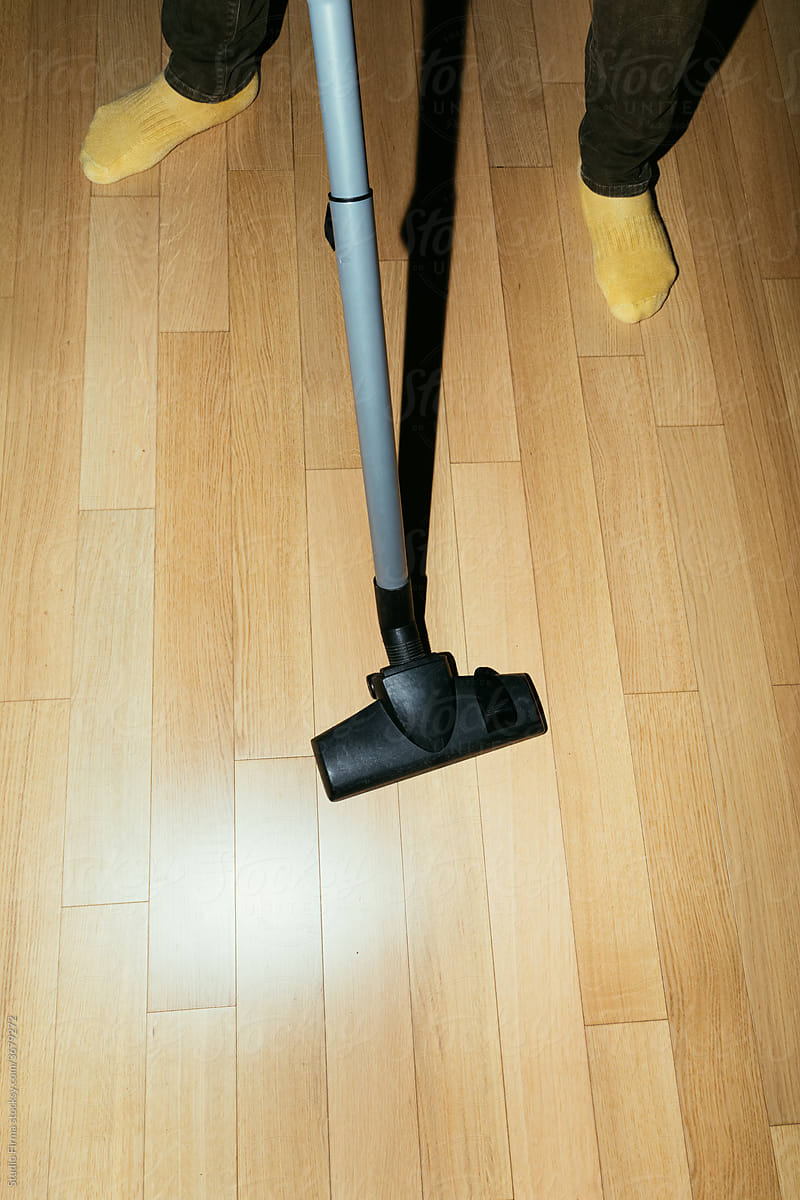 A Man Vacuuming at Home