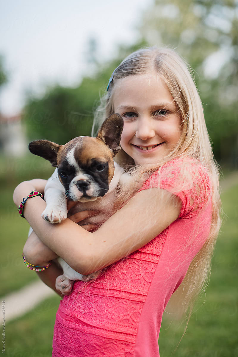 Young girl holding her new dog