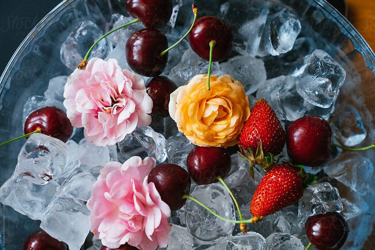 A plate with berries and ice.