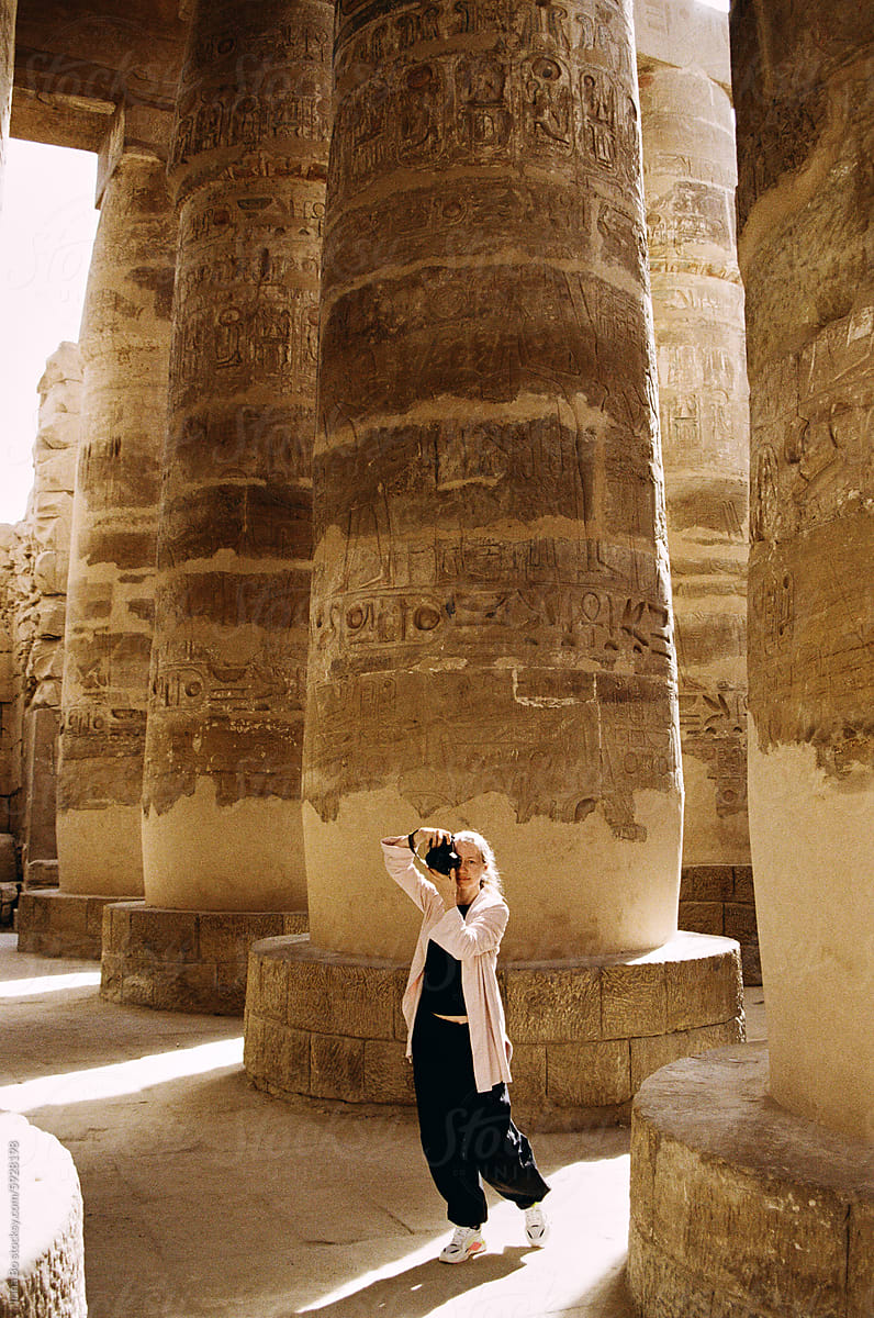 Tourist photographing columns of an ancient Egyptian temple