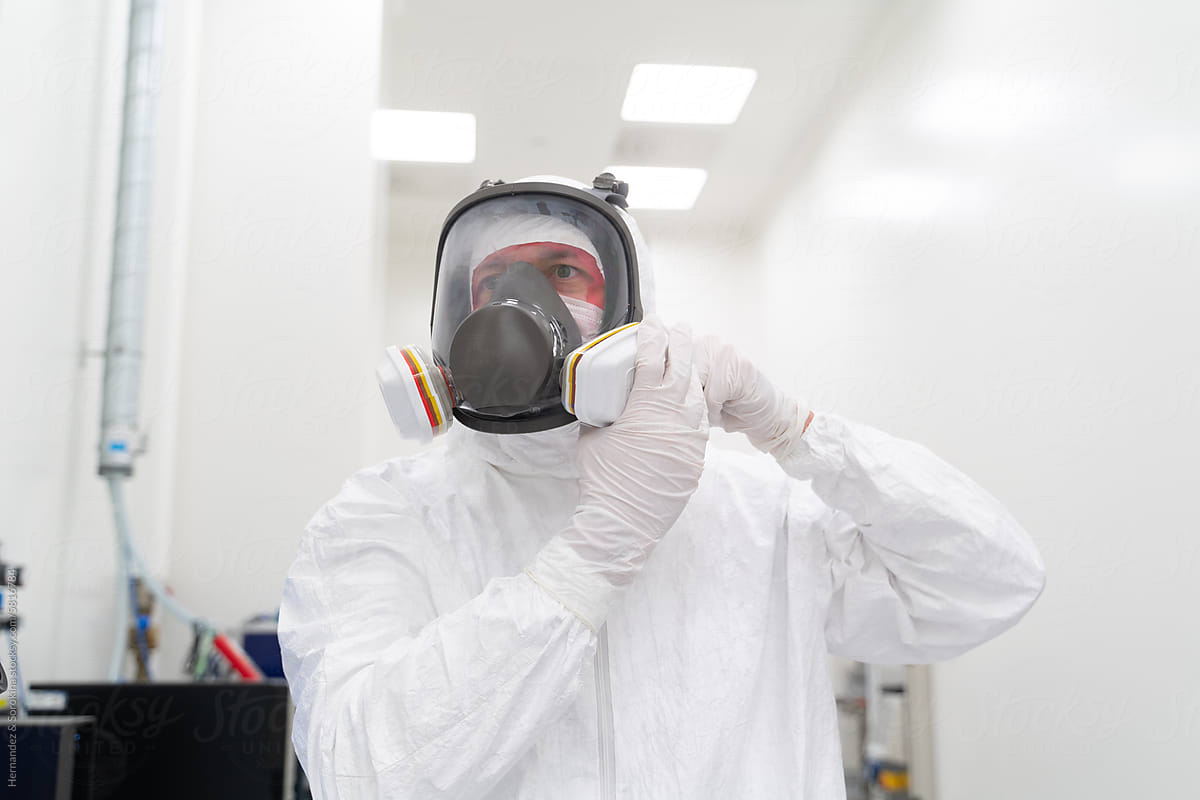 Scientist Putting Safety Helmet At Clean Room