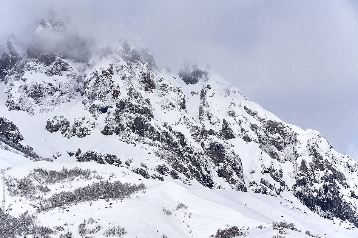 Severe landscape with snowy rocky mountain peak