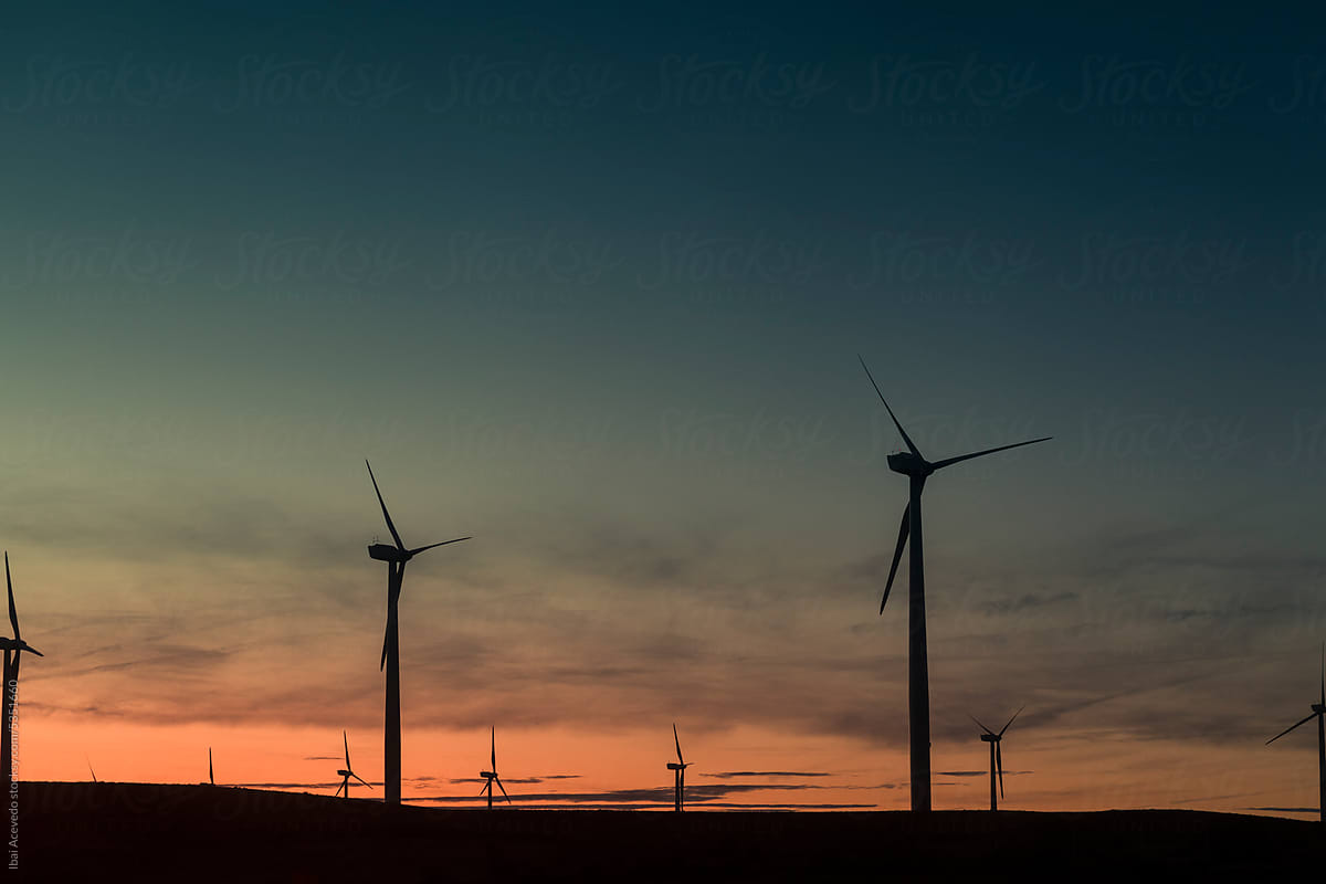 Wind turbines silhouettes during striking sunrise