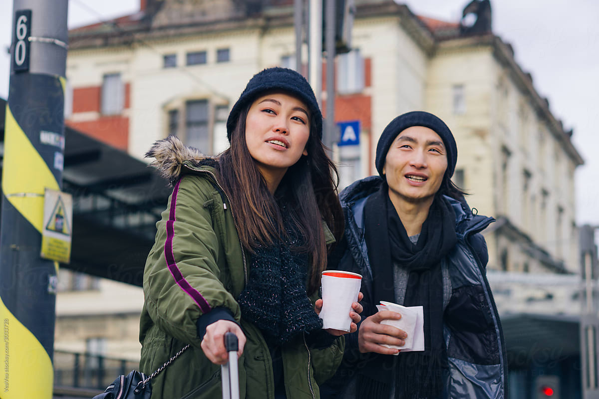 Asian couple waiting for a train in European city