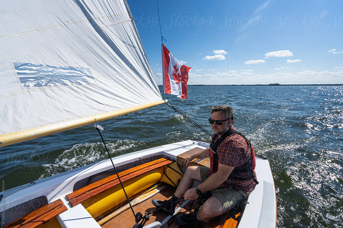 Man Sailing Wayfarer Sailboat on Lake Nipissing Canada