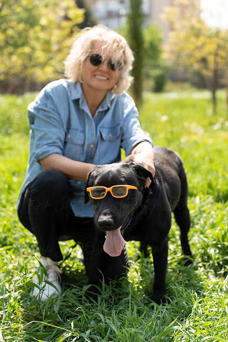 Portrait of lady with humorous dog in glasses