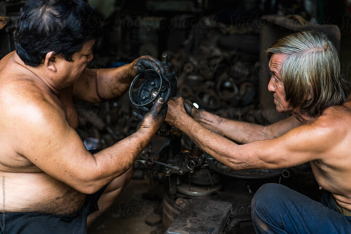 Men working in a mechanical workshop in Vietnam