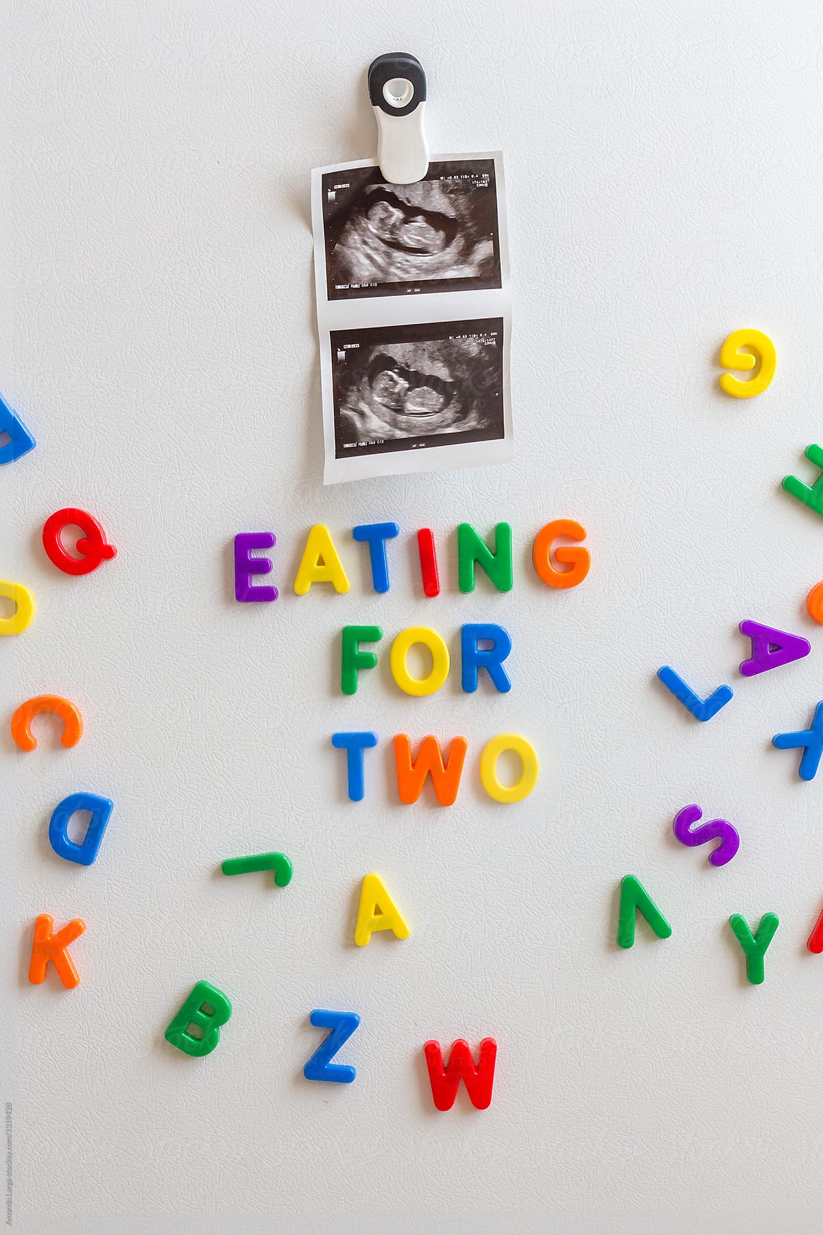 Fetal ultrasound image and magnetic letters on a fridge