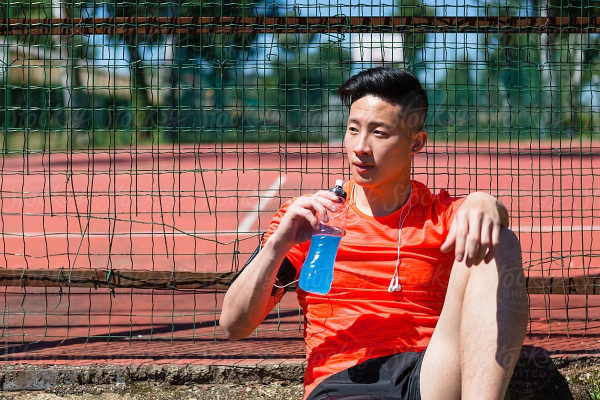 Asian Athlete Rest in Urban Area after Run
