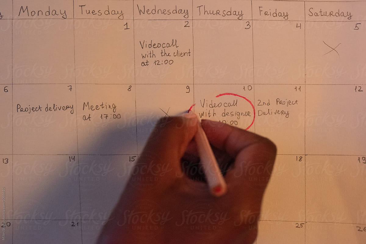 Female office worker circling note in schedule