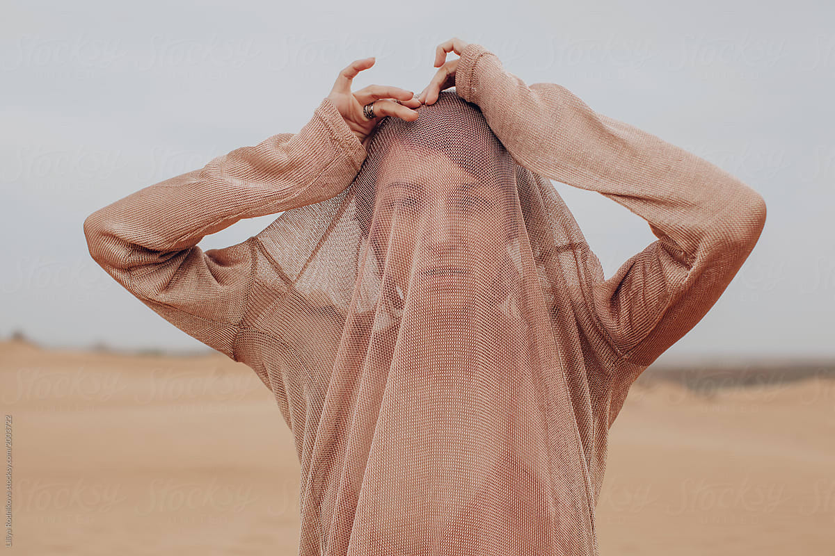 Woman Hiding Her Face With Clothes In Desrtt Del Colaborador De Stocksy Liliya Rodnikova 