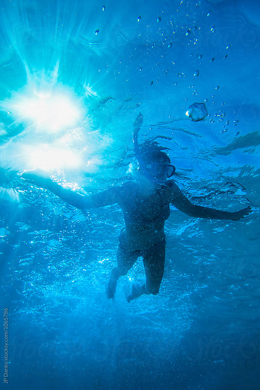 Silhouette of Woman Swimming Underwater at All Inclusive Caribbean Resort White Sand Beach
