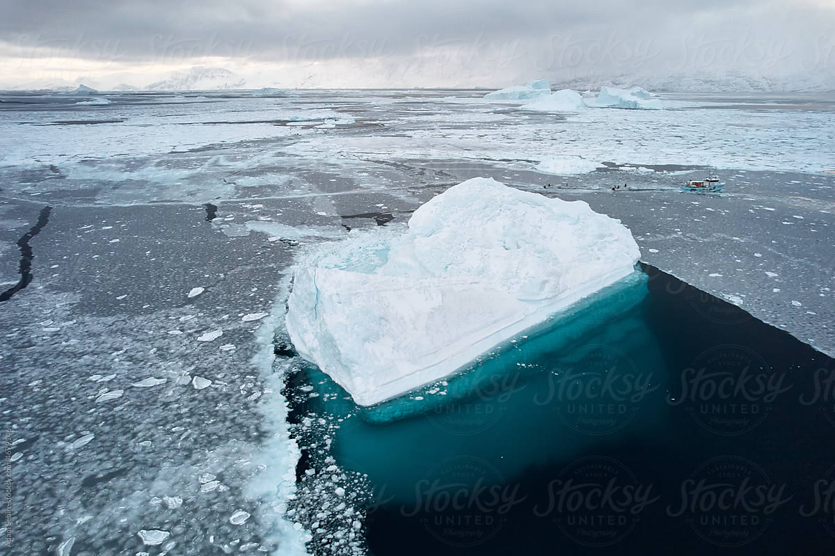 Arctic iceberg - large berg, transparent ocean, reveal sea below