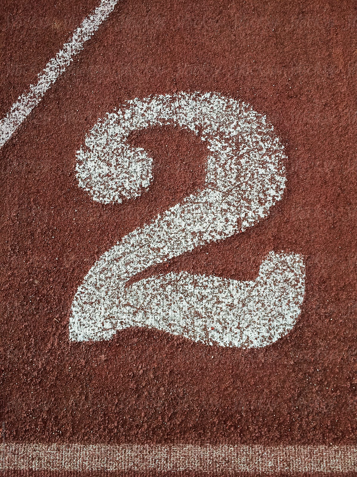 white number two painted on an running track