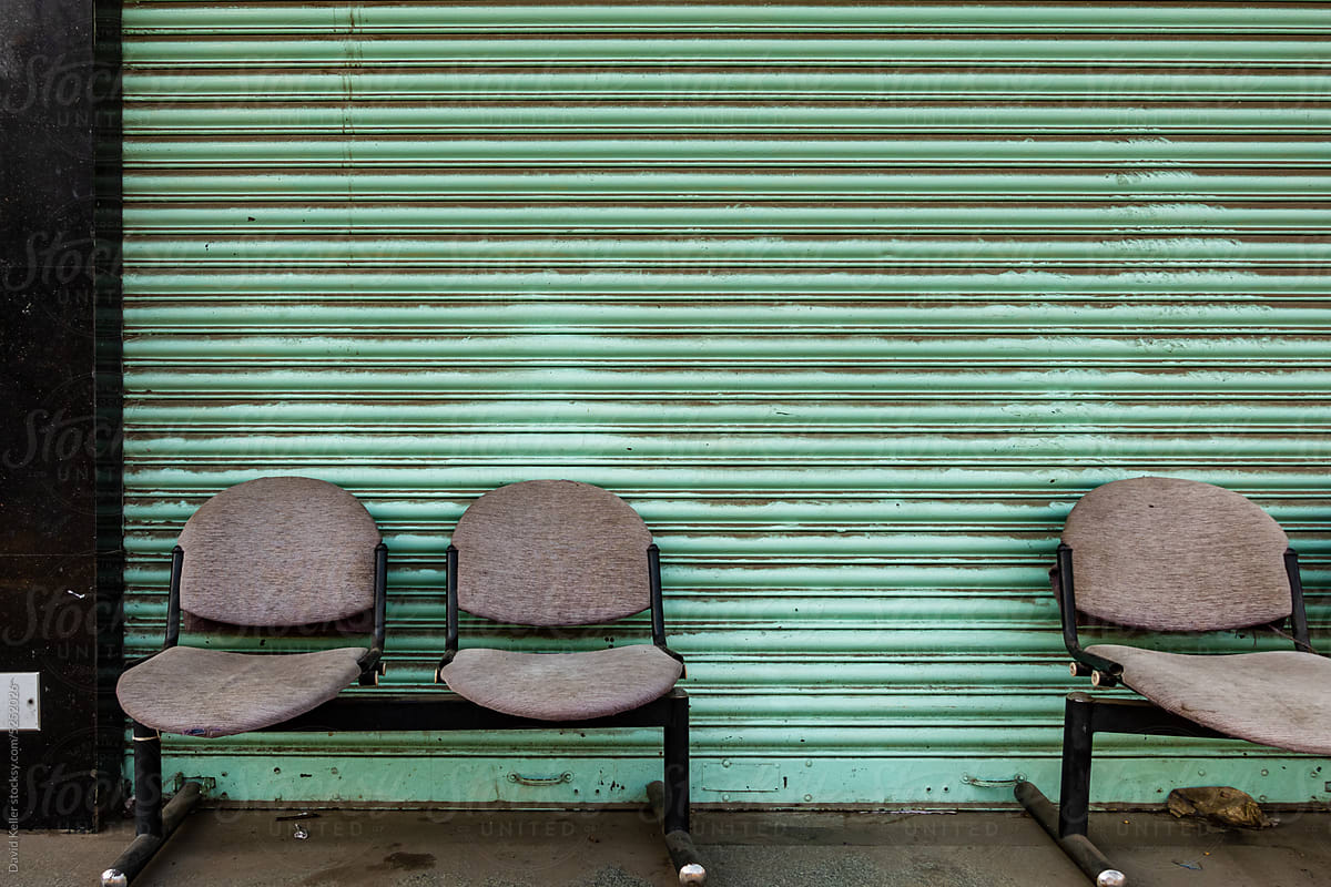Fixed chairs outside of a roll-up door