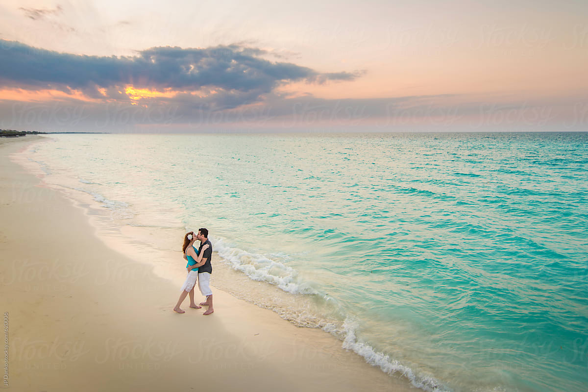 Aerial View Of Romantic Couple Kissing At Sunset On Tropical Caribbean Beach On Luxury Vacation 2369