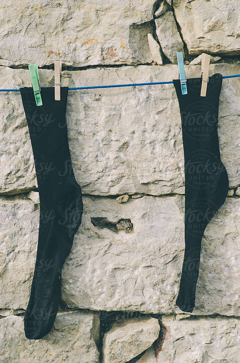 socks hung on a wall to dry