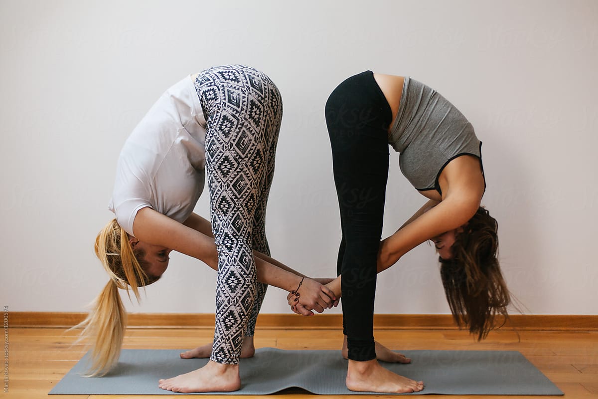 Two Women Doing Yoga Togethera by Stocksy Contributor Marija Kovac -  Stocksy