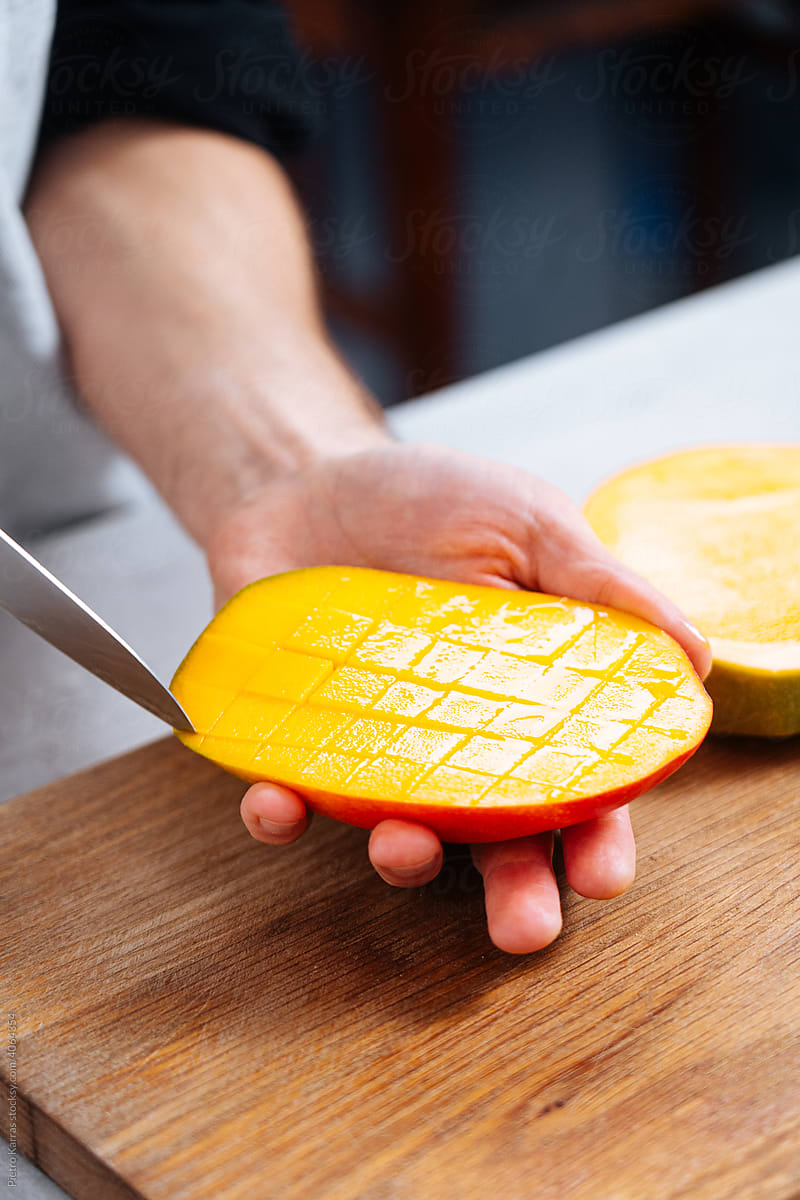 Chef cutting mango