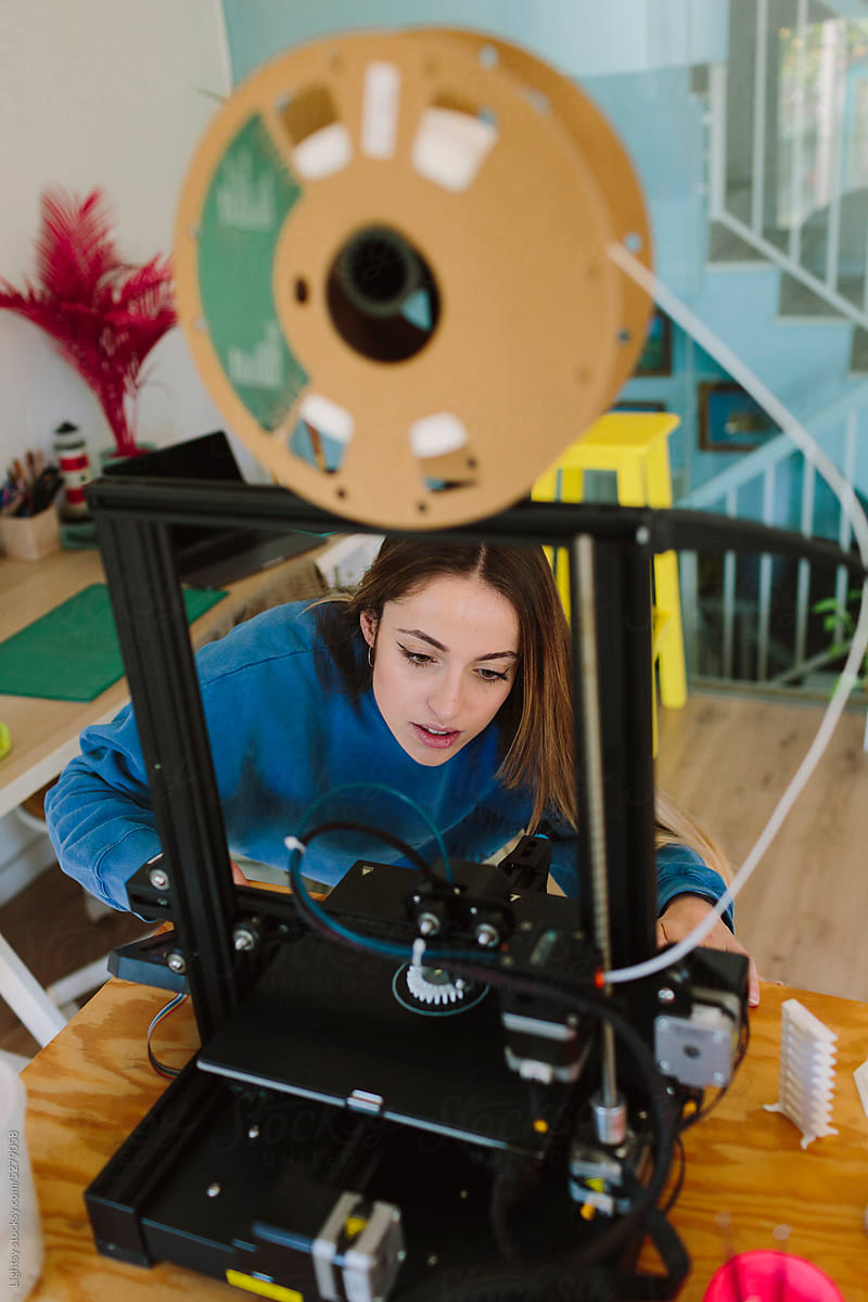Woman working with a 3D printer