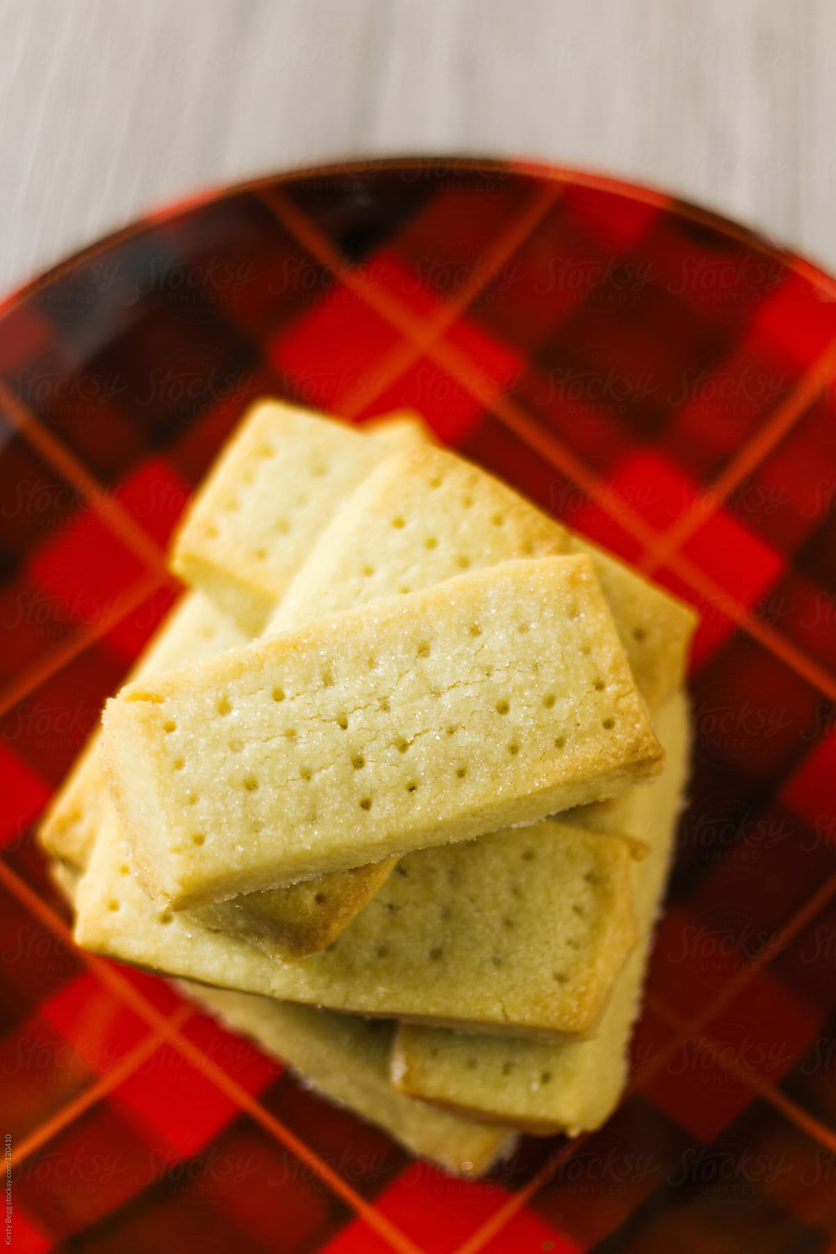 Stack of shortbread on red tartan plate