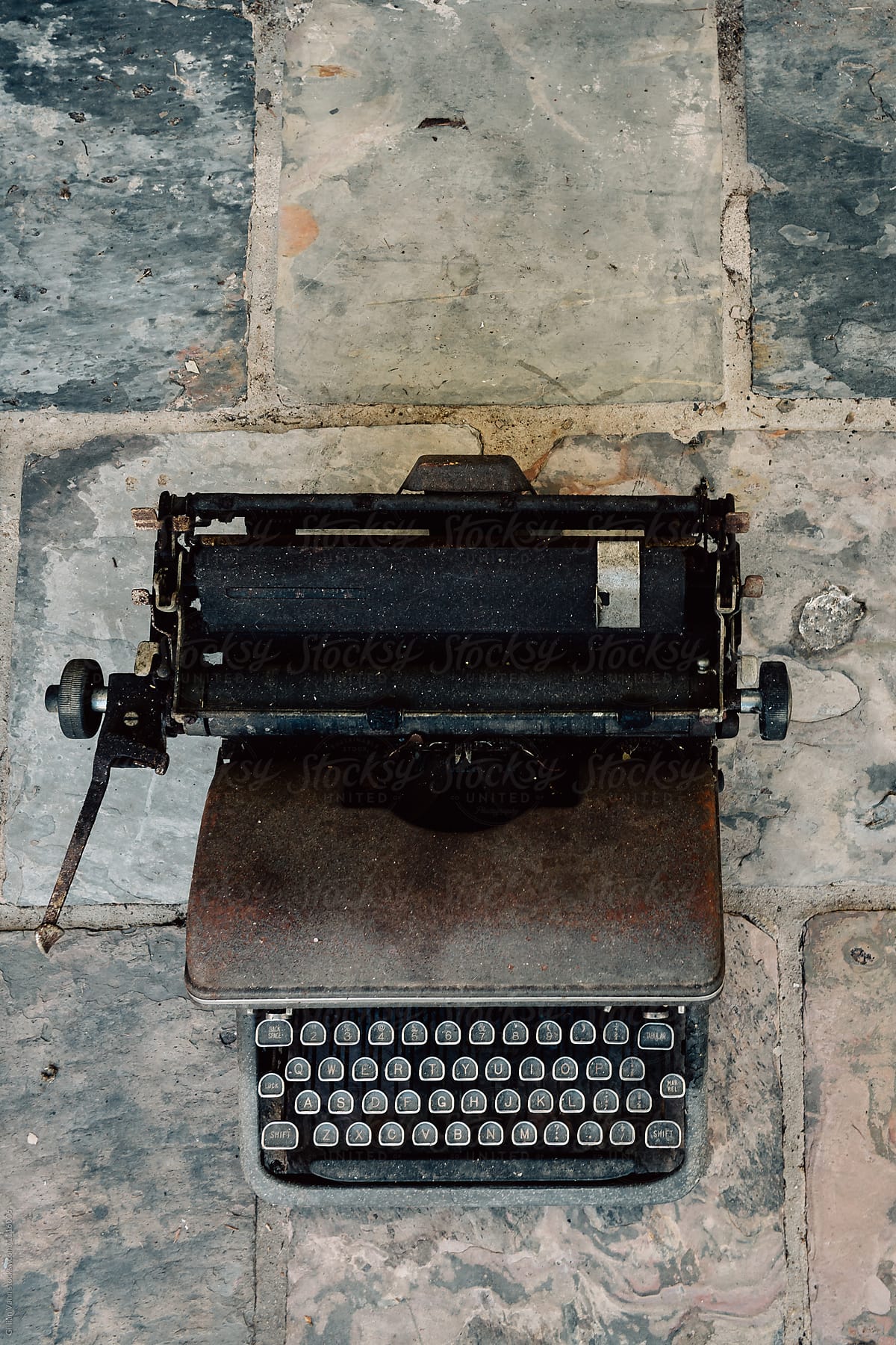 old vintage metal typewriter on a slate background