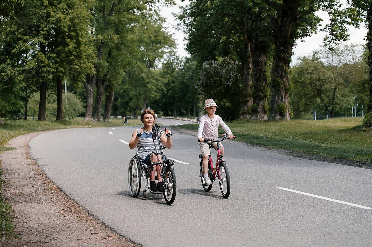 Mother and daughter riding on road together