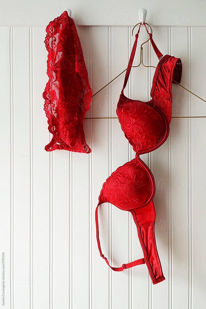 Closeup Of Red Lace Bras And Panties Hanging On Hooks By Stocksy Contributor Sandra