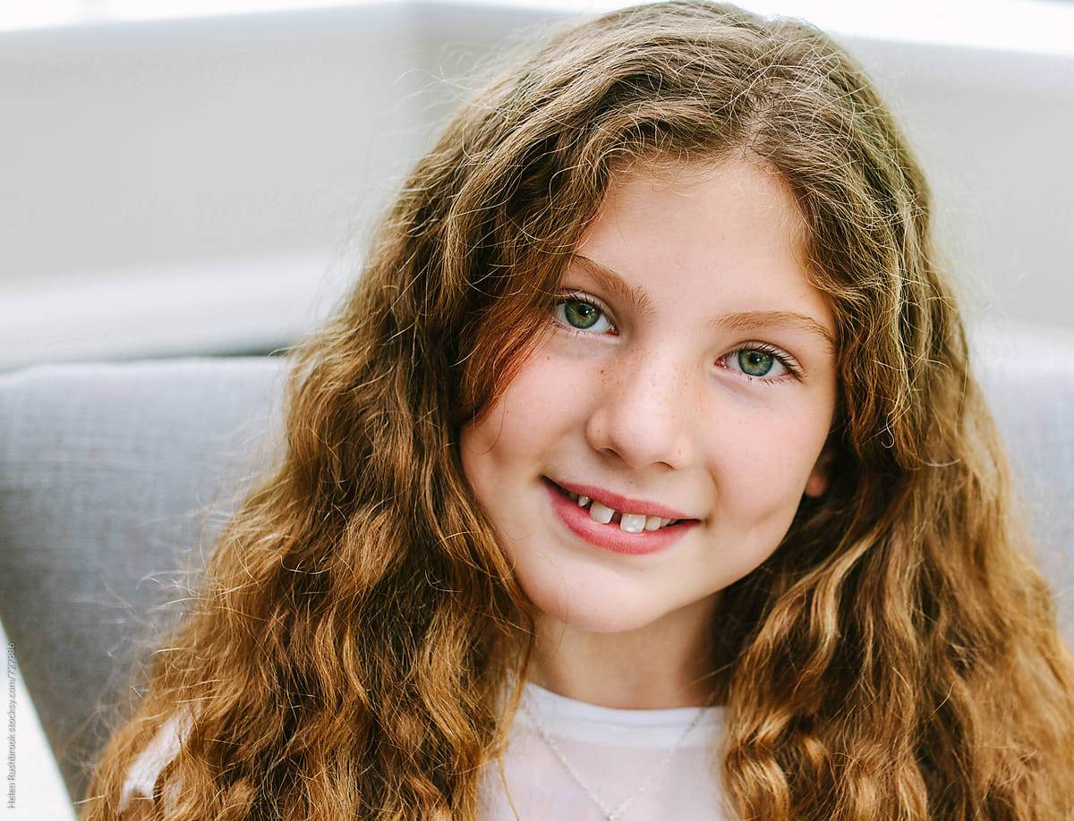 Girl With Long Curly Hair Smiling By Stocksy Contributor Helen