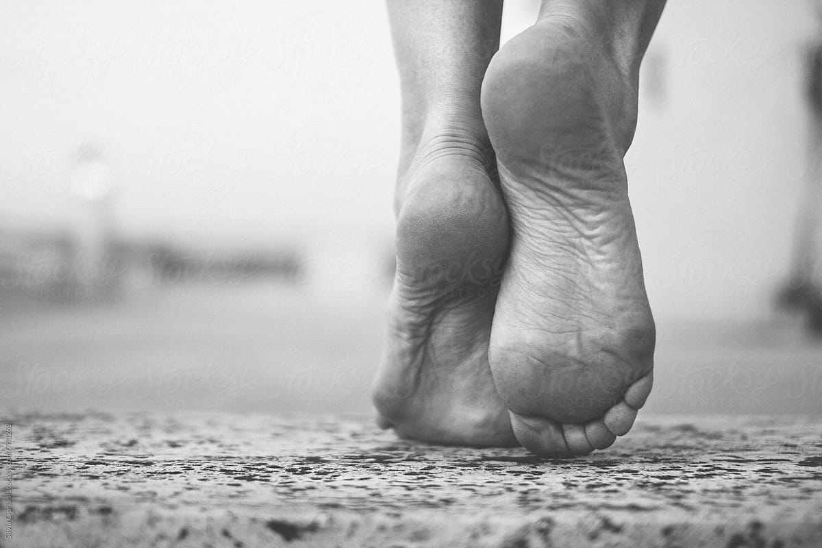 Barefoot woman stepping forward