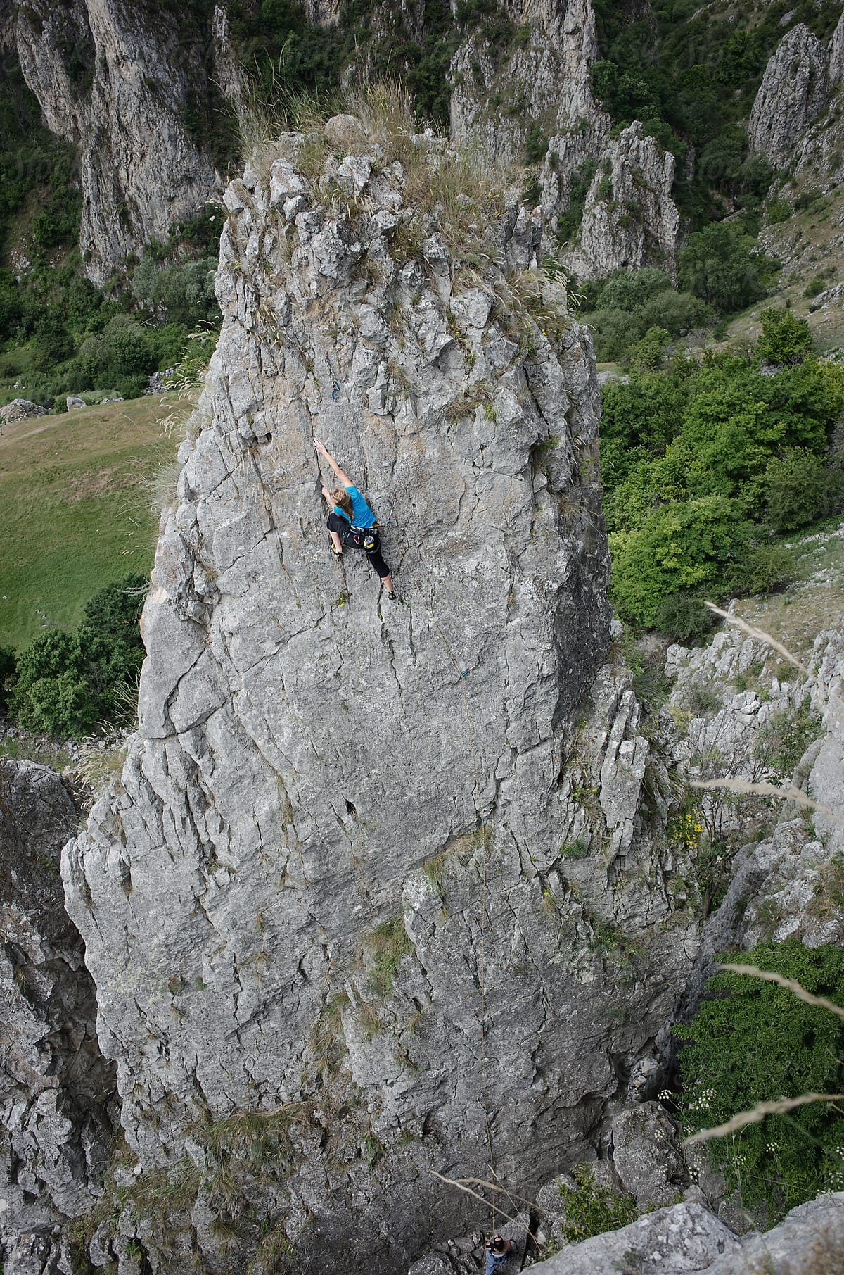 Woman rock climbing on a rock spike