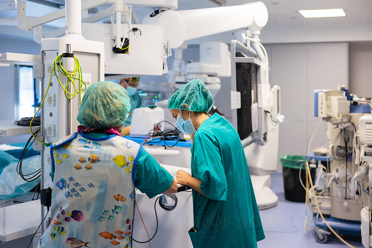 Group of doctors standing in modern hospital operating room