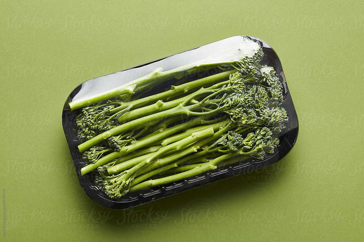 Box of green sprouts in plastic wrap