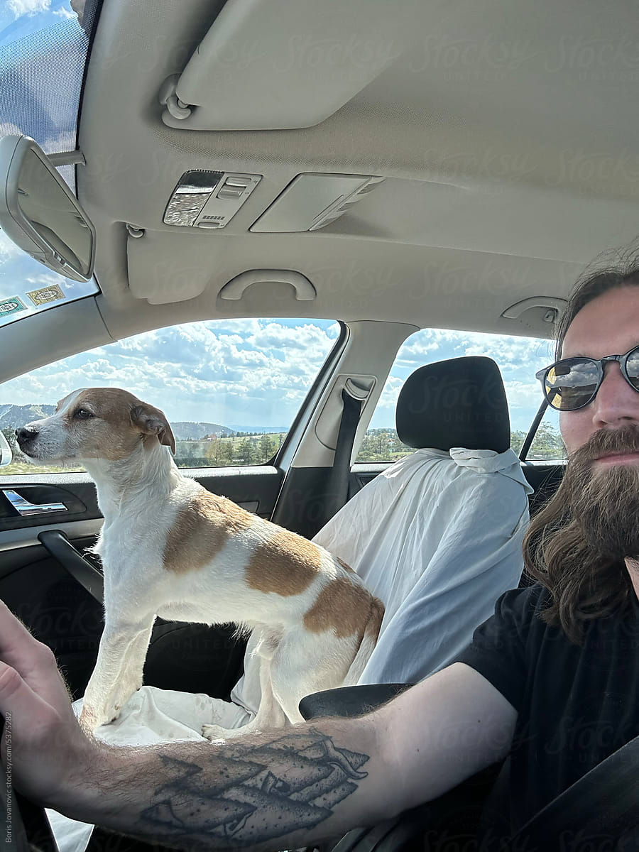 Self portrait of man and his dog in car