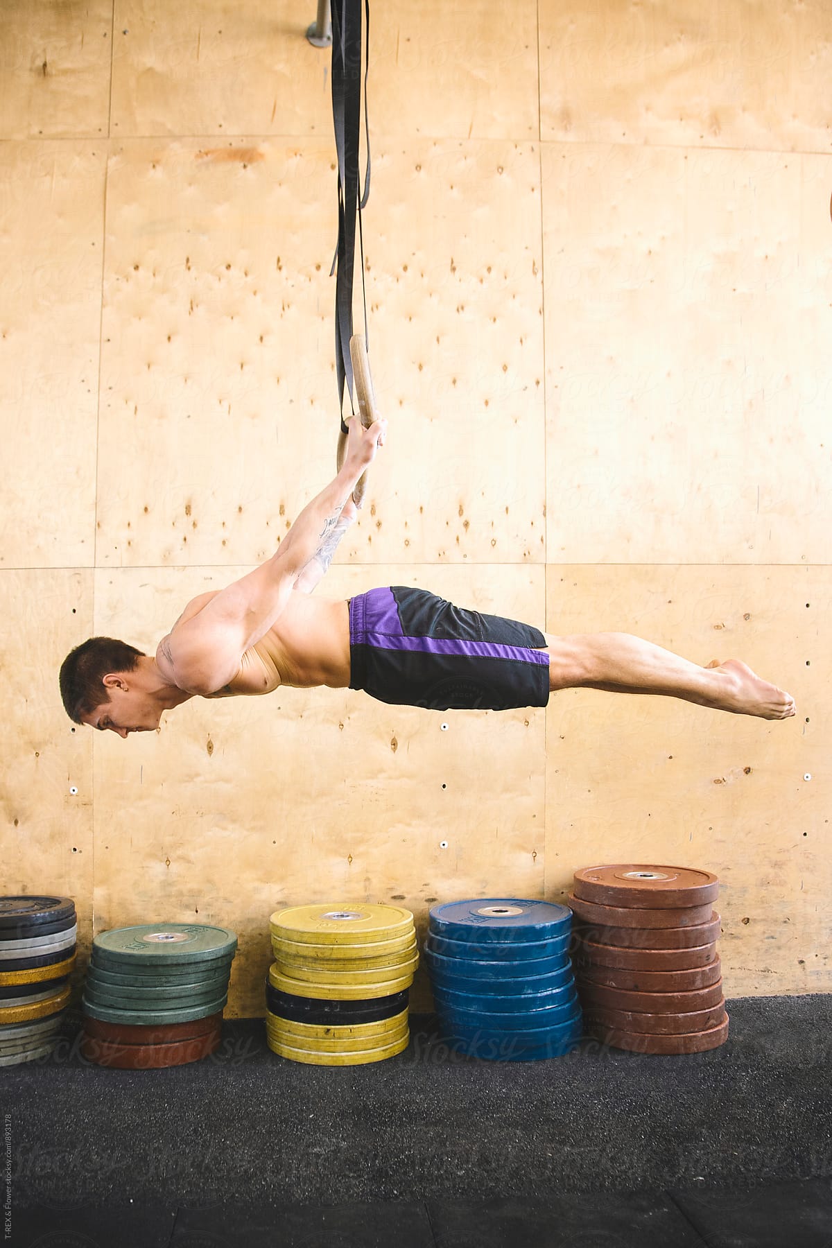 Man performing exercise on gymnastic rings