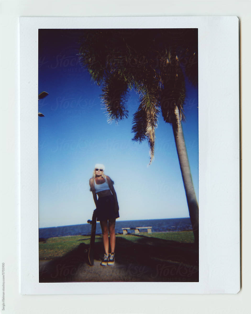 Polaroid Photo Of A Blonde Girl With Her by Stocksy