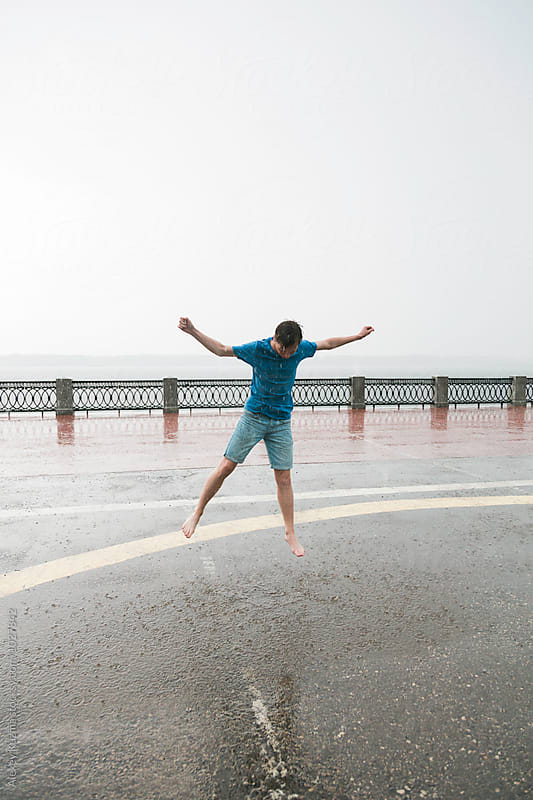 barefooted happy young man jumping