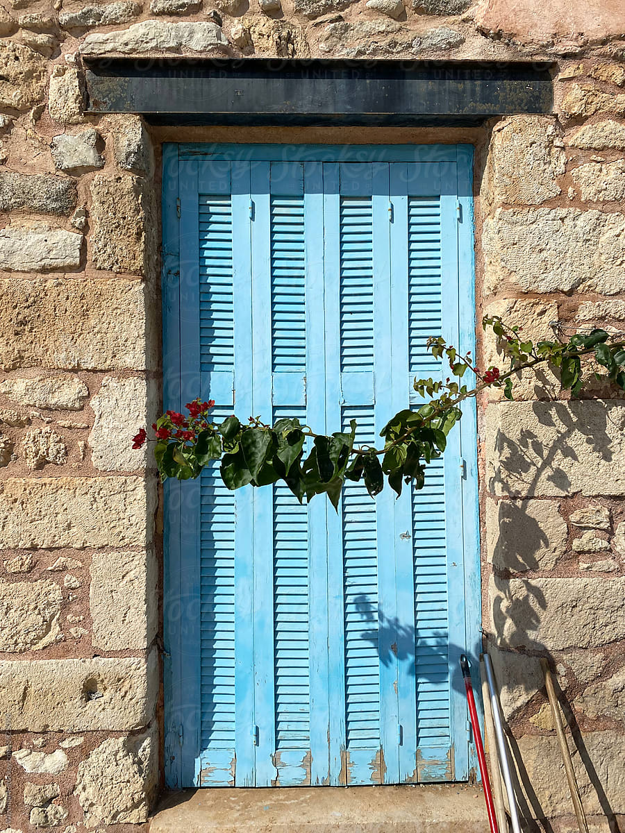 Closed blue window on an old Greek house.