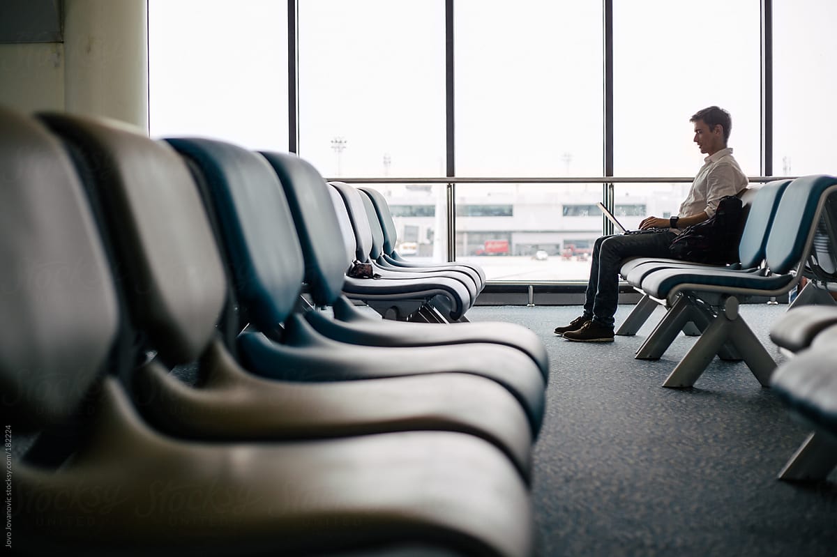 Man working at airport gate while waiting for flight