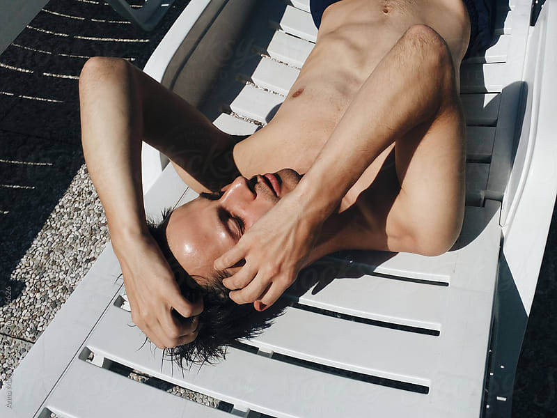 A young man sunbathes on the sun