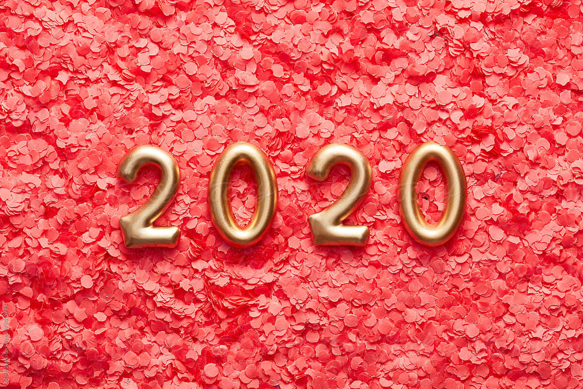 Golden 2020 numbers on pink confetti