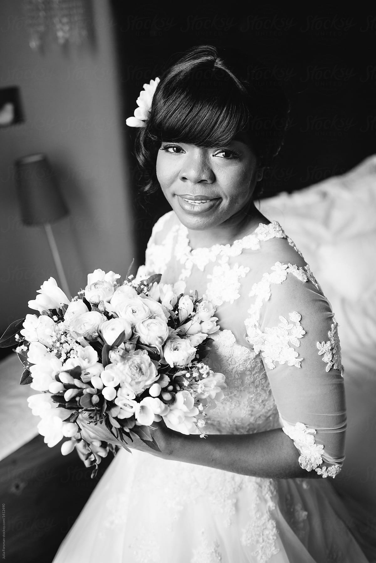 Portrait of African bride in lace wedding dress.