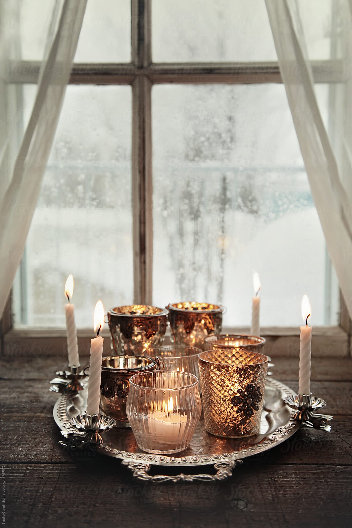 Votive candles on silver tray