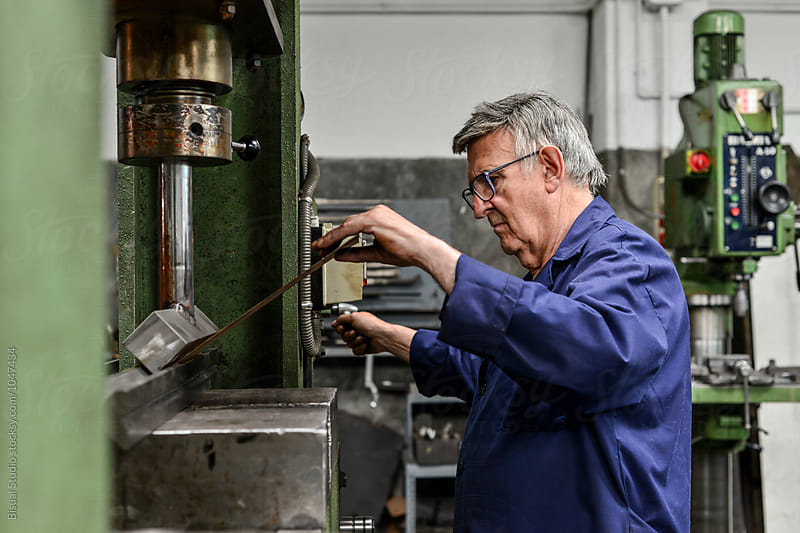 Senior man working with an hydraulic press