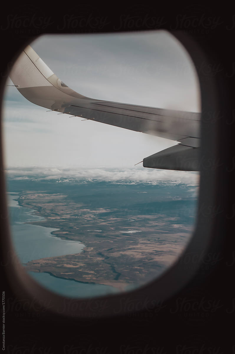 Viewpoint from a plane\'s window of the Patagonian land and ocean water in Chile