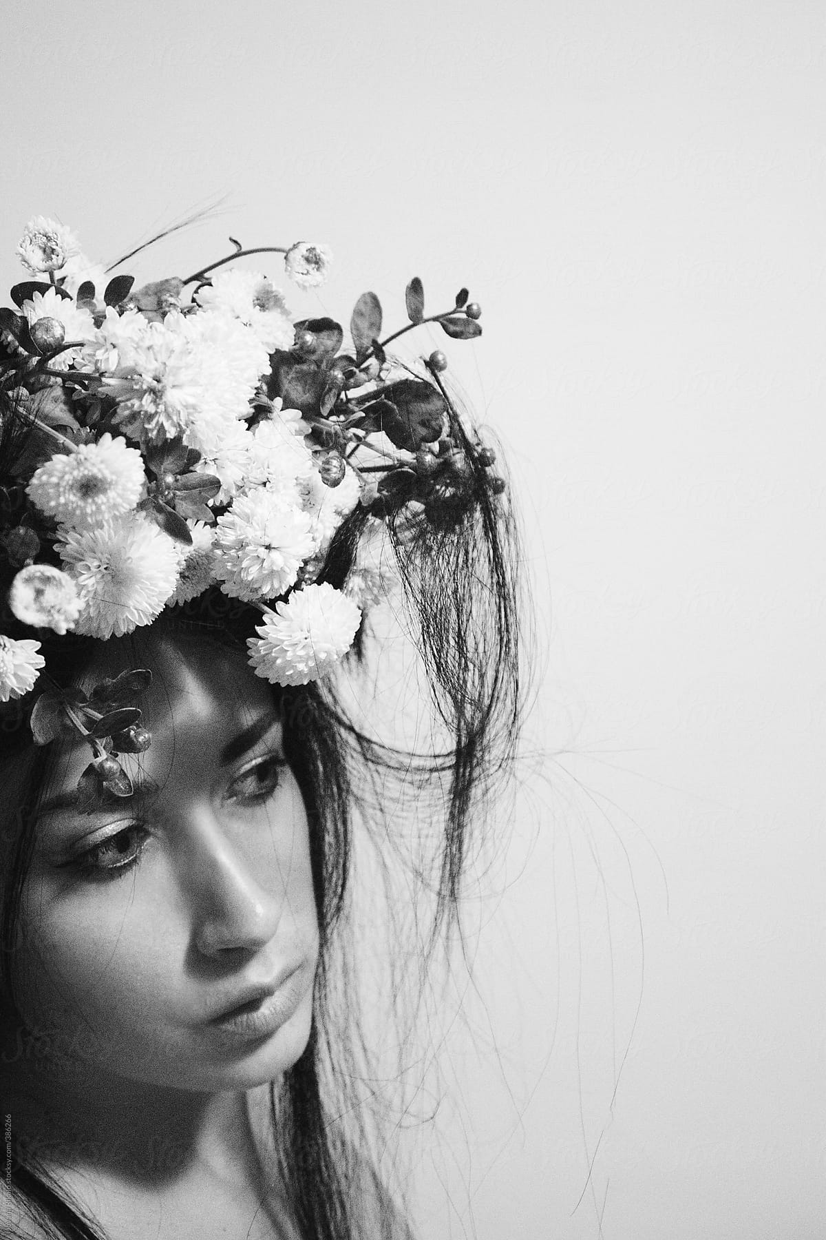 Young woman wearing a hat made of white flowers