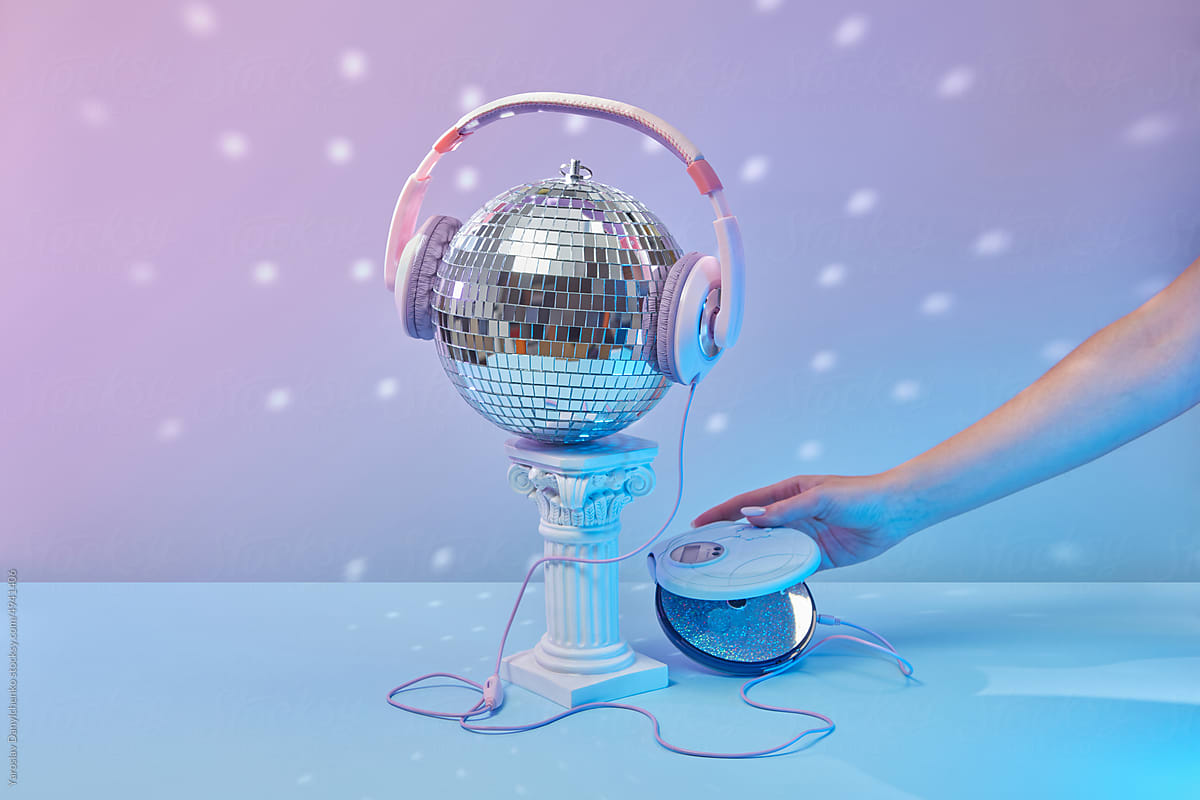 Disco ball in headphones, CD player in hand.