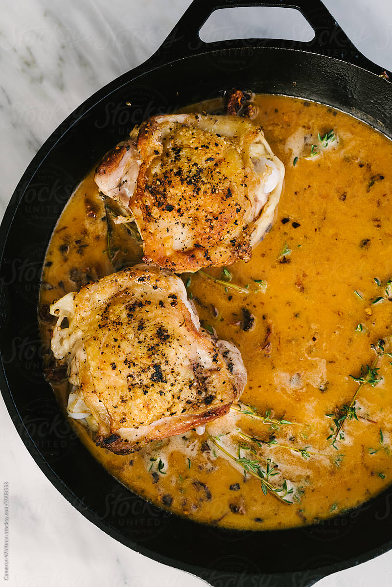 Chicken thighs cooking in their juices with Rosemary and coconut milk
