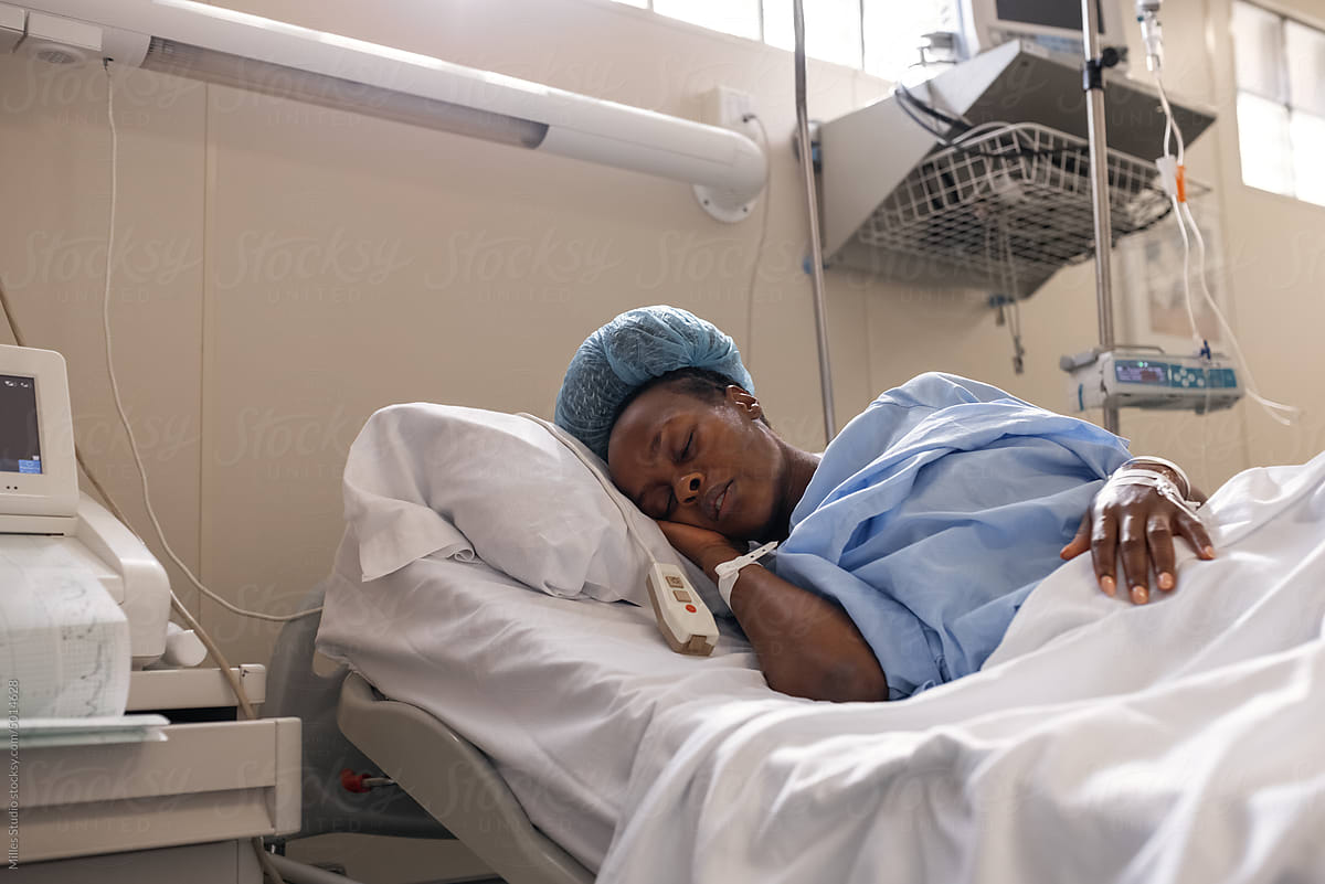 Exhausted African woman sleeping in labor room