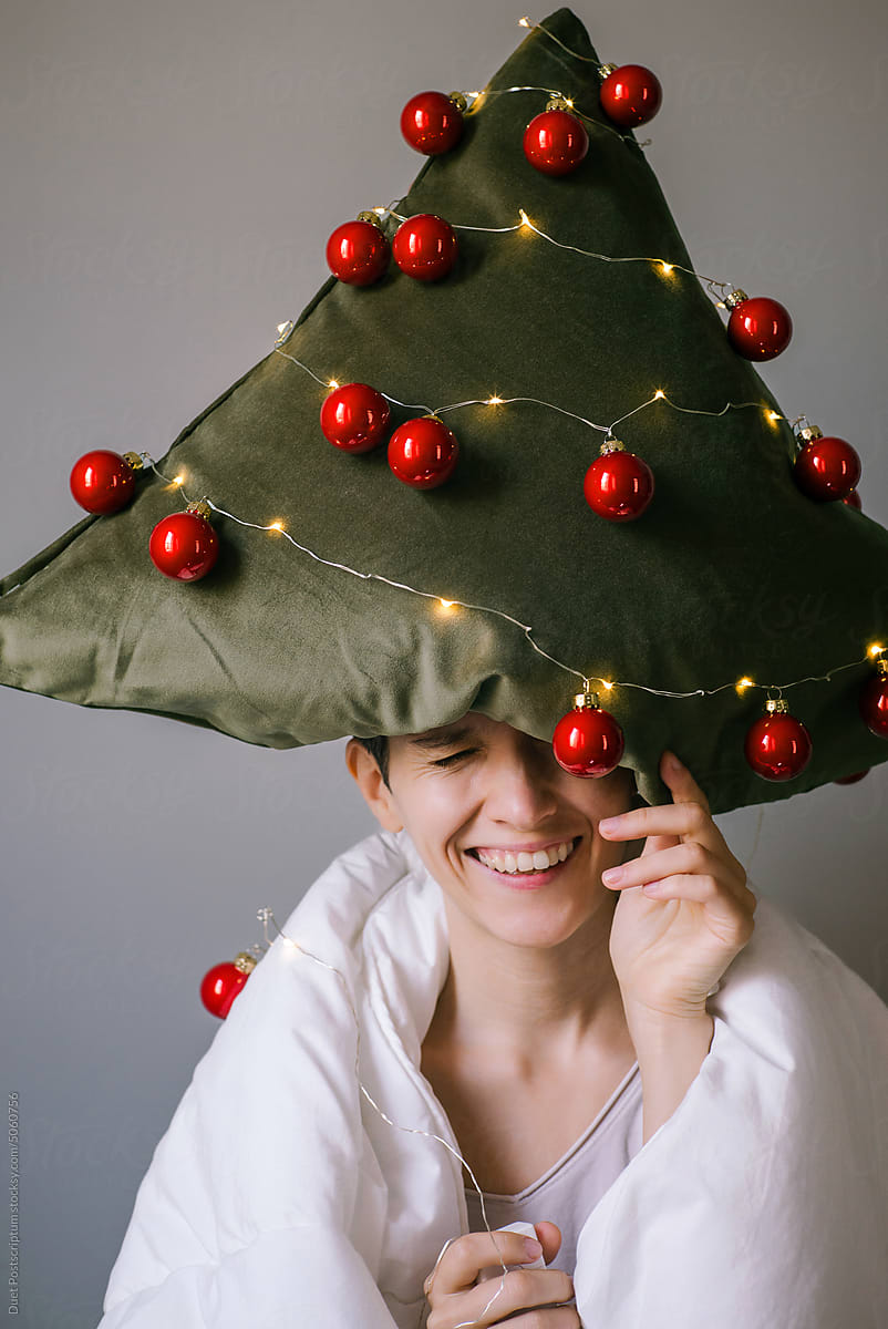 Cheerful young woman with pillow on her head.Christmas mood